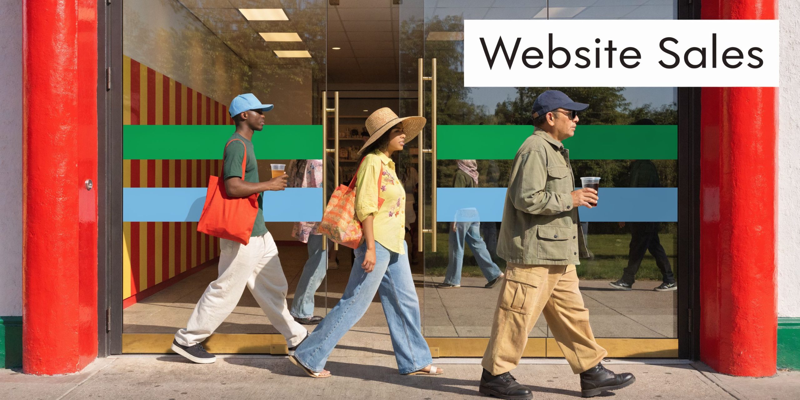 Three people walking out of a storefront with glass doors, holding drinks and shopping bags.